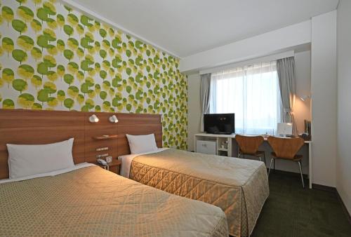 a hotel room with two beds and a desk at Hotel Migrant - Vacation STAY 81252v in Tateyama