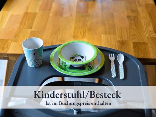 a tray with a plate and a bowl and a cup at Fewo River I Familienfreundlich I großer Garten I inkl Badefass I Kamin I Spielplatz in Wendisch Rietz