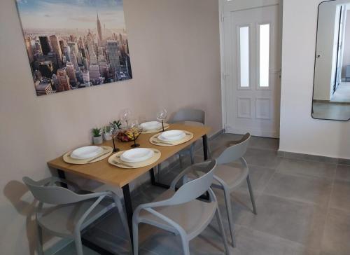 a dining room with a wooden table and chairs at Apartments Danijela in Tribunj