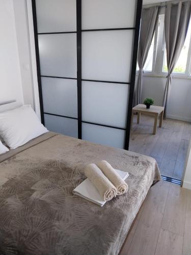 a bedroom with a bed with two towels on it at Apartments Danijela in Tribunj