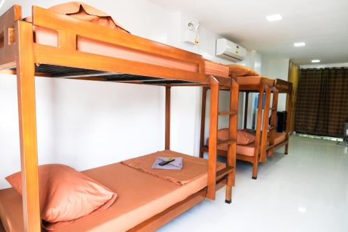 a bedroom with three bunk beds in a room at Hangout Haven Siargao Homestay in Dapa