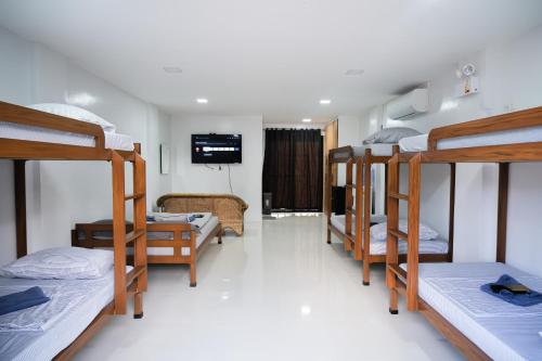 a dorm room with a bunch of bunk beds at Hangout Haven Siargao Homestay in Dapa