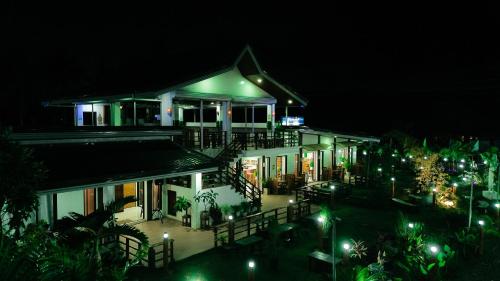 a house at night with lights in front of it at Hangout Haven Siargao Homestay in Dapa
