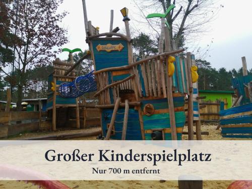 a playground with a play equipment with the words grouker k kindergartenidad at Fewo River I Familienfreundlich I großer Garten I inkl Badefass I Kamin I Spielplatz in Wendisch Rietz