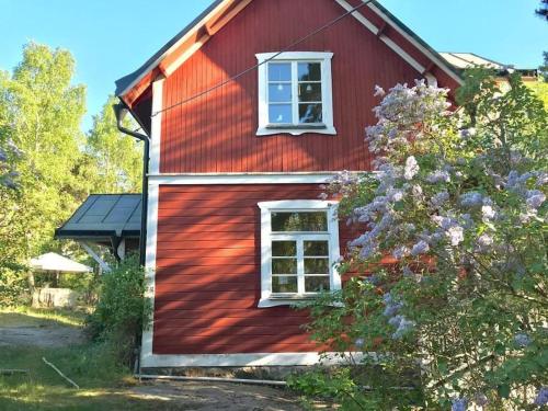 a red house with a window on the side of it at Vaxholm Skarpö archipelago island living with car access in Vaxholm