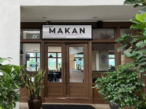 a restaurant with a sign over the door at Tune Hotel KLIA Aeropolis (Airport Hotel) in Sepang