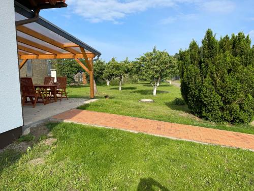 a patio with a table and chairs in a yard at Am Gallowayhof in Seehausen
