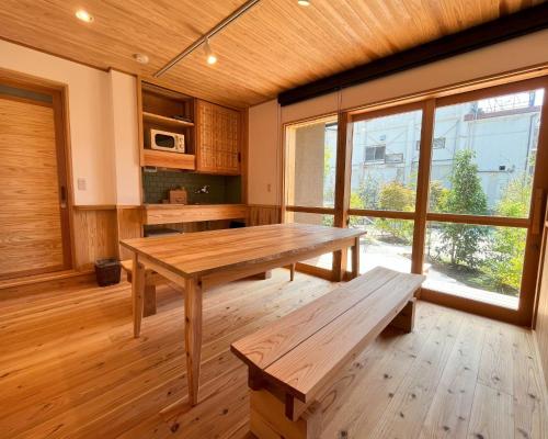 a large room with a wooden table and benches at Matsu no Yu Tokiwa - Vacation STAY 56390v in Yatsushiro