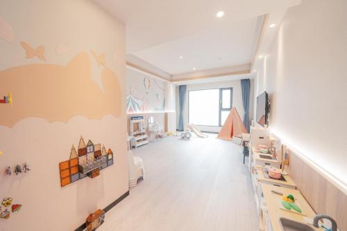 a childs room with a cloud mural on the wall at Hotel Liyaou in Chiayi City