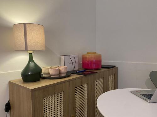 a table with a lamp on top of a cabinet at The Urban Westlake Apartment in Hanoi