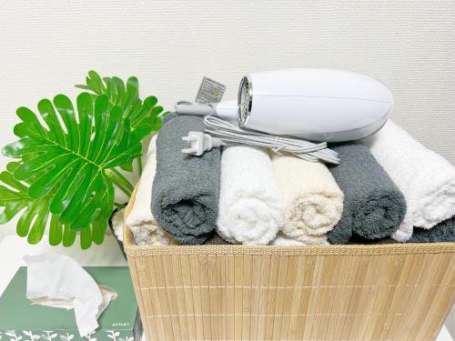 a basket with a hair dryer on top of towels at 高田馬場4分 最大7人 02 in Tokyo