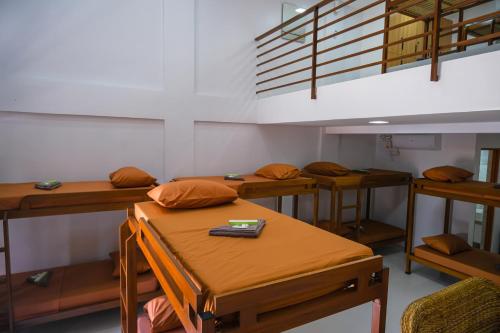 a room with several tables and bunk beds at Hangout Haven Siargao Homestay in Dapa