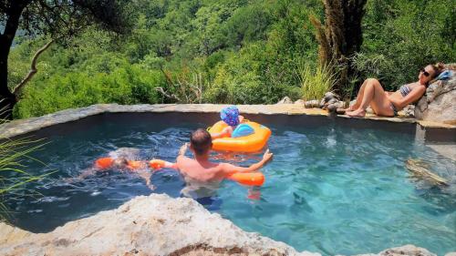 a group of people in a pool of water at Hoopoe Glamping in Virpazar
