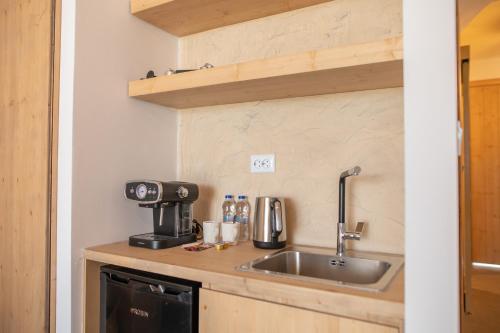 a kitchen with a sink and a coffee maker at Li Mango in Tigaki