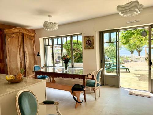 a dining room with a glass table and chairs at Face Mer Villa Le Ker Breton in Pornichet
