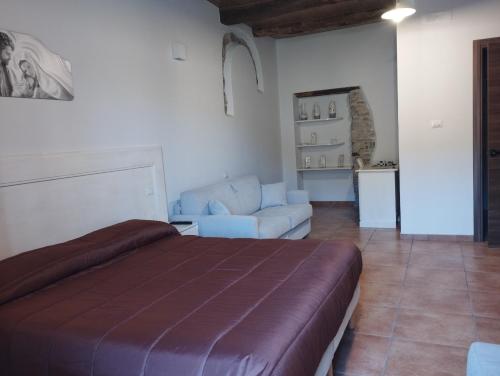 Ein Bett oder Betten in einem Zimmer der Unterkunft L'Arco Antico