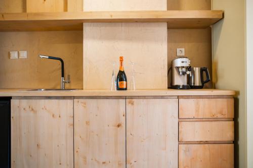 a bottle of wine sitting on a counter in a kitchen at Li Mango in Tigaki