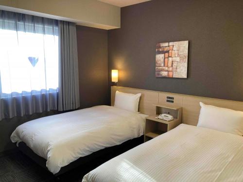 Кровать или кровати в номере Hotel Route-Inn Kashima