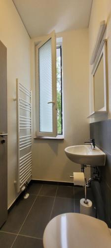 a bathroom with a sink and a window at Queens Residenz in Berlin