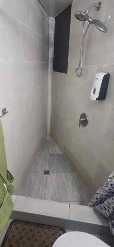 a bathroom with a shower with a toilet at Full size 2 bedrooom 2 bath condo split in Sosúa