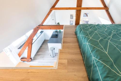 a loft conversion with a bed and a desk at Hoog e in Eindhoven