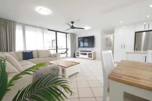 a living room with a couch and a table at Seaview Resort in Mooloolaba