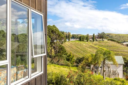 a window view of a vineyard from a house at Vineyard Magic, Onetangi in Onetangi
