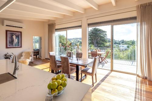 a kitchen and living room with a table and chairs at Vineyard Magic, Onetangi in Onetangi