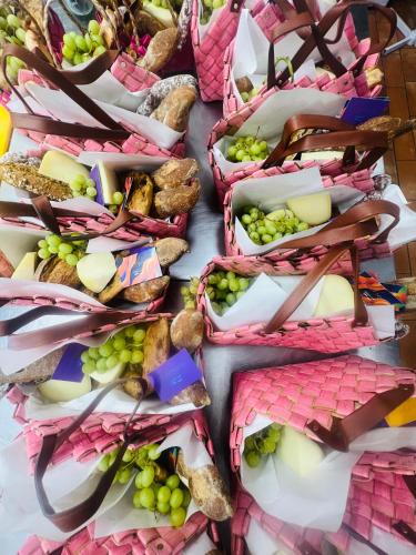 a table filled with baskets of grapes and bread at Country House Ca' Vernaccia in Urbino