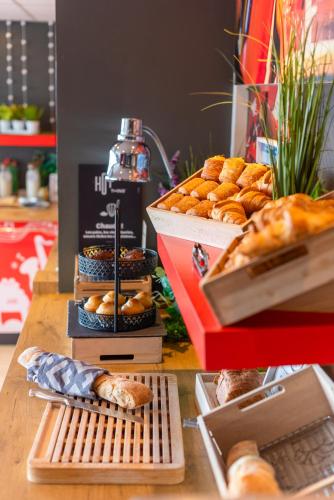 a table with a bunch of bread and pastries at ibis Chalon Sur Saone Nord in Chalon-sur-Saône