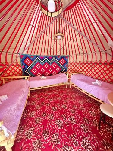 a room with two beds in a yurt at Eco Resort Kaiyrma in Bokonbayevo