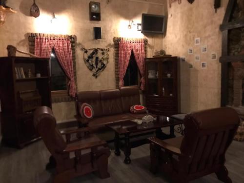 a living room with a couch and chairs and a table at Apartman dado in Bosanska Gradiška