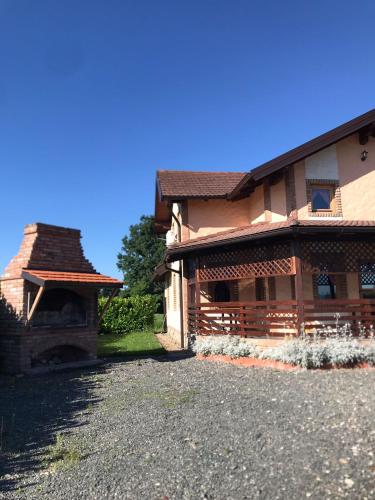 a house with a stone driveway in front of it at Apartman dado in Bosanska Gradiška