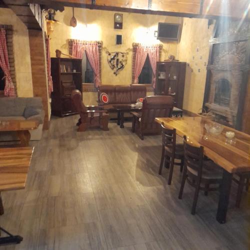 a living room with wooden floors and tables and a couch at Apartman dado in Bosanska Gradiška