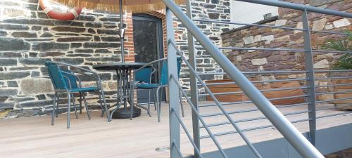a balcony with blue chairs and a bar stool at La Marina in Guipry-Messac