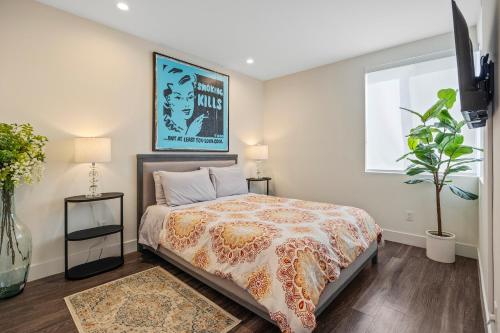 a bedroom with a bed and two tables and a window at 2 Santa Monica Beach Walking in Los Angeles