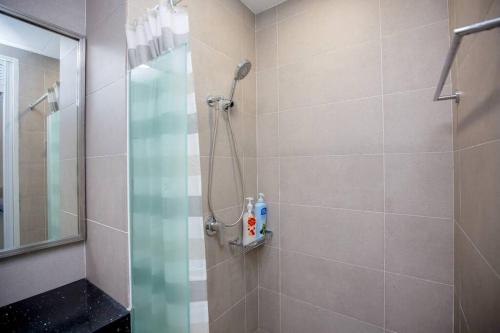a bathroom with a shower with a glass door at Tropicana 218 Spacious Luxury City 3BedRoom 3 Car park 11pax in George Town