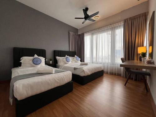 a bedroom with two beds and a ceiling fan at Tropicana 218 Spacious Luxury City 3BedRoom 3 Car park 11pax in George Town