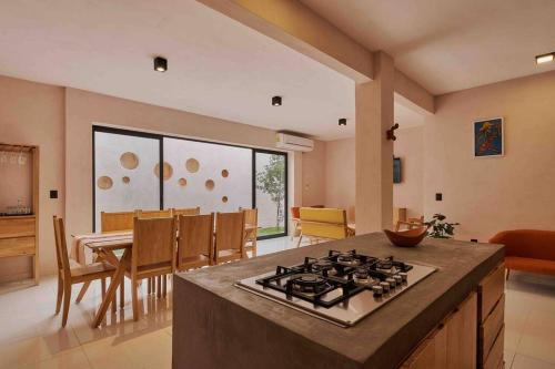 a kitchen and dining room with a stove top oven at Casa Boutique Peñasco Oaxaca in Oaxaca City