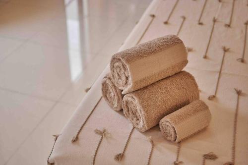 a stack of three towels sitting on a towel at Casa Boutique Peñasco Oaxaca in Oaxaca City