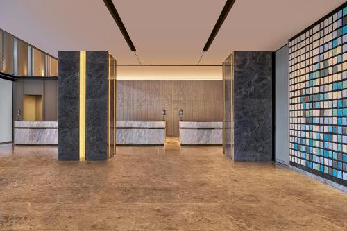a lobby with a row of stalls in a building at Marriott Executive Apartments Penang in George Town