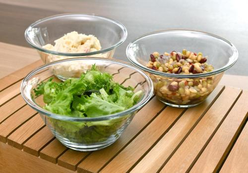 three bowls of food sitting on a wooden table at Washington R&B Hotel Shin Yokohama Ekimae in Yokohama