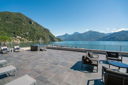a patio with a view of the water and mountains at Villa Navalia in Menaggio