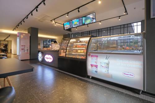 a bakery with a large display case with pastries at Metro Park View Hotel Kota Lama Semarang in Semarang