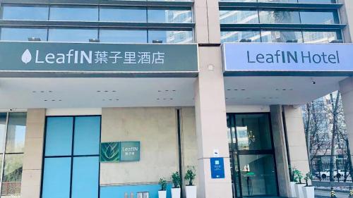 a building with a sign for a learin hotel at LeafIN Hotel Beijing Wangjing SOHO in Beijing