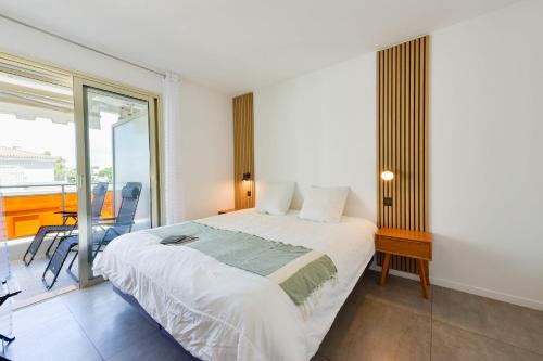 une chambre avec un grand lit et un balcon dans l'établissement Renovated 1Br apartment terrace walk to beach, à Cannes