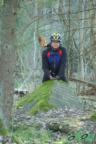a person sitting on a rock in the woods at Pokoje w Gołdapi in Gołdap