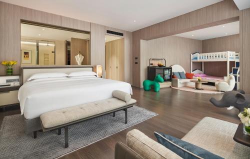a bedroom with a large bed and a play room at Intercontinental Shenzhen Dameisha Resort by IHG in Shenzhen