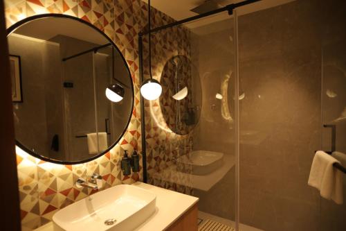 a bathroom with a sink and a mirror at Ramada by Wyndham Gorakhpur Gorakhnath Mandir Road in Gorakhpur
