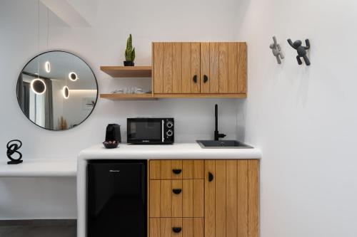 a kitchen with a black refrigerator and a mirror at LyMaRou Collection in Megalokhori